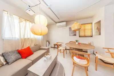 a living room with a couch and a table at Wooden warmth of a house 8 people Skytree 7 minutes 75 square meters Asakusa, Shibuya, Narita, Haneda direct in Tokyo