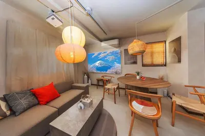 a living room with a couch and a table at Wooden warmth of a house 8 people Skytree 7 minutes 75 square meters Asakusa, Shibuya, Narita, Haneda direct in Tokyo
