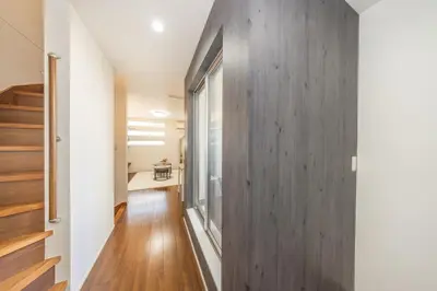 a hallway with a wood paneled wall in a house at 9-min walk to Ikebukuro Station, 1-min walk to Kanamecho Station Max 8 guests 70 sqm Free parking Direct access to Shinjuku, Shibuya, Ueno in Tokyo
