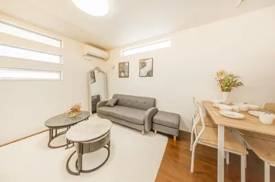 a living room with a couch and a table at 9-min walk to Ikebukuro Station, 1-min walk to Kanamecho Station Max 8 guests 70 sqm Free parking Direct access to Shinjuku, Shibuya, Ueno in Tokyo