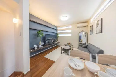 a living room with a table and a couch at 9-min walk to Ikebukuro Station, 1-min walk to Kanamecho Station Max 8 guests 70 sqm Free parking Direct access to Shinjuku, Shibuya, Ueno in Tokyo