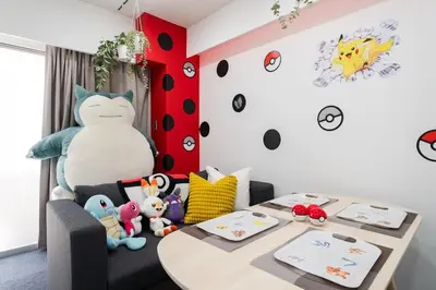 a room with a table and a chair with stuffed animals at AT Akihabara No3 in Tokyo