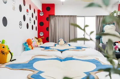 a bedroom with a large bed with stuffed animals on it at AT Akihabara No3 in Tokyo