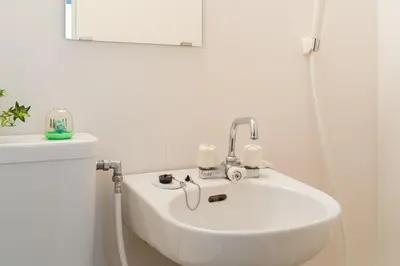 a white sink in a bathroom with a mirror at AT Akihabara No3 in Tokyo