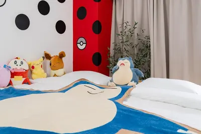 a bedroom with a bed with stuffed animals on it at AT Akihabara No3 in Tokyo