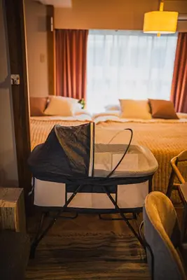 a room with two beds and a table and a chair at AT Akihabara No3 in Tokyo