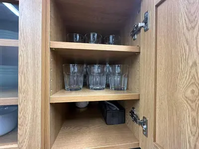 a cupboard with four empty glasses in it at Rest Collection SEIWA LODGE Tokyo in Tokyo