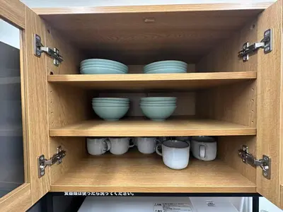 a cupboard with blue bowls and mugs in it at Rest Collection SEIWA LODGE Tokyo in Tokyo