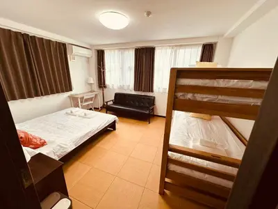 a bedroom with a bunk bed and a couch at Rest Collection SEIWA LODGE Tokyo in Tokyo