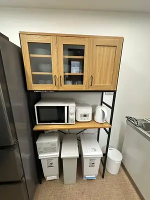 a cabinet with a microwave and other appliances on it at Rest Collection SEIWA LODGE Tokyo in Tokyo