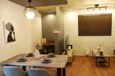 a dining room with a wooden table and chairs at New Shibuya Area House 6 pax with Skyline View in Tokyo