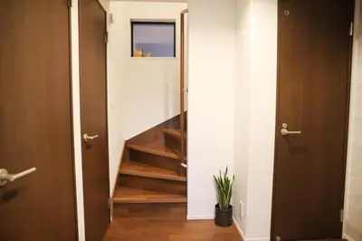 a hallway with a staircase with wooden floors and doors at New Shibuya Area House 6 pax with Skyline View in Tokyo