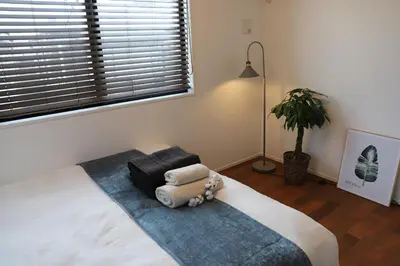 a bedroom with a large bed with a large window at New Shibuya Area House 6 pax with Skyline View in Tokyo