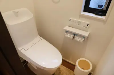 a bathroom with a white toilet and a television at New Shibuya Area House 6 pax with Skyline View in Tokyo