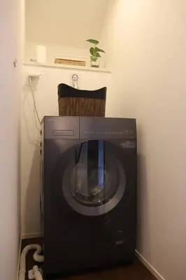 a washing machine with a chair on top of it at New Shibuya Area House 6 pax with Skyline View in Tokyo