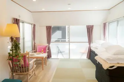 a bedroom with a bed and a table with a chair at Tokyo Tower Area 301 Tamachi & Mita Walk Balcony Stay in Tokyo
