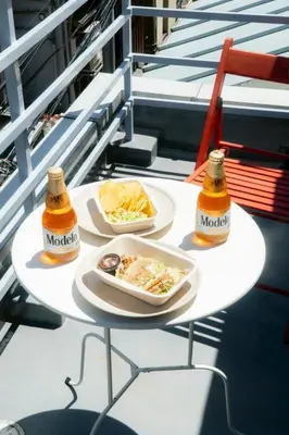 a table with two plates of food and two bottles of mustard at Tokyo Tower Area 301 Tamachi & Mita Walk Balcony Stay in Tokyo