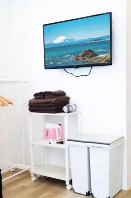 a flat screen tv hanging on a wall at Tokyo Tower Area 301 Tamachi & Mita Walk Balcony Stay in Tokyo