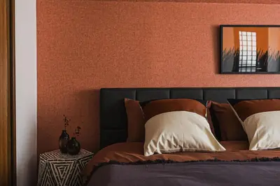 a bedroom with a bed with an orange wall at Shibuya Area, 5-min to Shinjuku, 7-min to Sta, 4BR in Tokyo