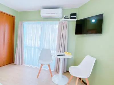 a room with a table and two chairs and a window at 401, 6 min walk to subway stn, Tokyo Univ, Tokyo Tower, Tokyo-Dome direct by subway in Tokyo
