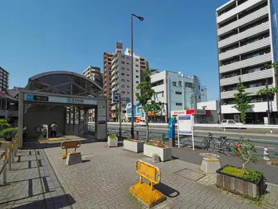 a city street with a yellow bench and buildings at 401, 6 min walk to subway stn, Tokyo Univ, Tokyo Tower, Tokyo-Dome direct by subway in Tokyo