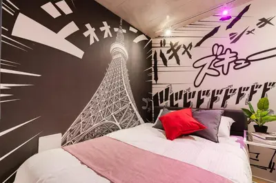 a bedroom with a mural of the eiffel tower at ARiA STAY SHINAGAWA in Tokyo
