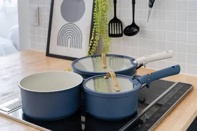 two pots sitting on top of a stove in a kitchen at ARiA STAY SHINAGAWA in Tokyo