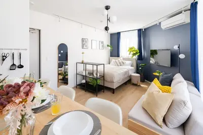 a living room with a couch and a table at ARiA STAY SHINAGAWA in Tokyo