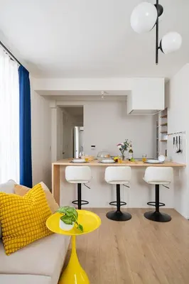 a living room with a couch and a yellow table at ARiA STAY SHINAGAWA in Tokyo