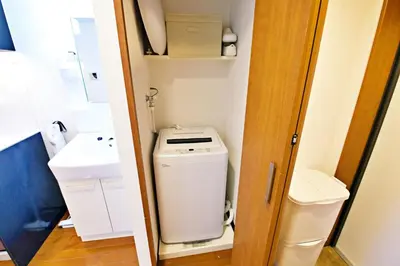 a small bathroom with a toilet and a sink at Gaia Shinjuku 503 in Tokyo