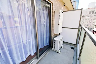 a balcony with a window and an air conditioner at Gaia Shinjuku 503 in Tokyo
