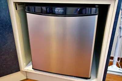 a stainless steel refrigerator sitting in a shelf at Gaia Shinjuku 503 in Tokyo
