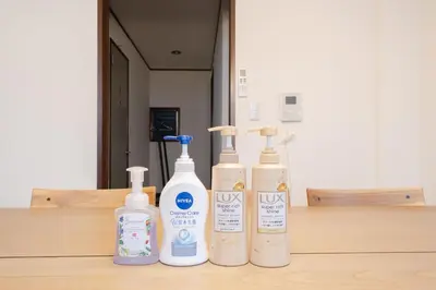 four bottles of cleaning products sitting on a wooden table at Tokyo Skytree view Oshiage Sta 3 min by car 6bed in Tokyo
