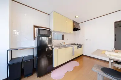 a kitchen with a black refrigerator and a counter at Tokyo Skytree view Oshiage Sta 3 min by car 6bed in Tokyo