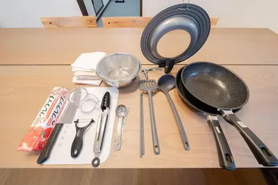 a table with utensils and a strainer and a frying pan at Tokyo Skytree view Oshiage Sta 3 min by car 6bed in Tokyo
