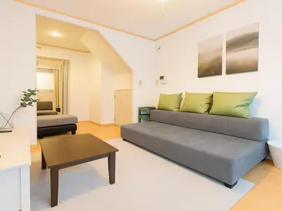 a living room with a couch and a table at Ikebukuro-Otsuka-10min ShinOtsuka Sta-For families and groups-Switch-net-Mobile Wi-Fi in Tokyo