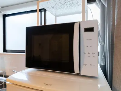 a microwave oven sitting on top of a table at Ikebukuro-Otsuka-10min ShinOtsuka Sta-For families and groups-Switch-net-Mobile Wi-Fi in Tokyo