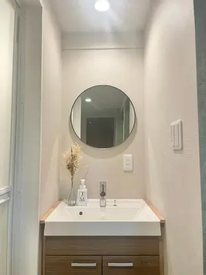 a bathroom with a sink and a mirror at Hotel Kototoi Juku HAKU in Tokyo