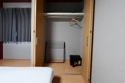 a bedroom with a closet with a bed and a chair at Rakuna Inn Nizi - Oshiage 2 - Vacation STAY 46832v in Tokyo