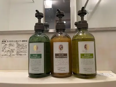 three bottles of olive oil sitting on a shelf at Rakuna Inn Nizi - Oshiage 2 - Vacation STAY 46832v in Tokyo