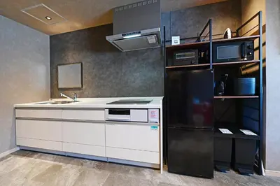 a kitchen with a black refrigerator and a sink at Rakuna Inn Nizi - Oshiage 2 - Vacation STAY 46832v in Tokyo