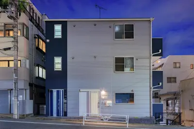 a white building on a city street at night at Cityzen Tokyo in Tokyo