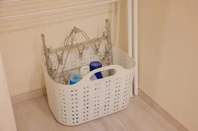 a white basket sitting on the floor in a room at Cityzen Tokyo in Tokyo