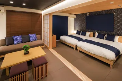 a bedroom with a large bed and a couch at Cityzen Tokyo in Tokyo