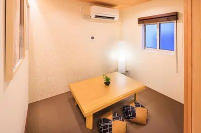 a small room with a wooden table and a window at Cityzen Tokyo in Tokyo