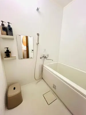 a white bathroom with a sink and a bath tub at Tokyo Ami House in Tokyo