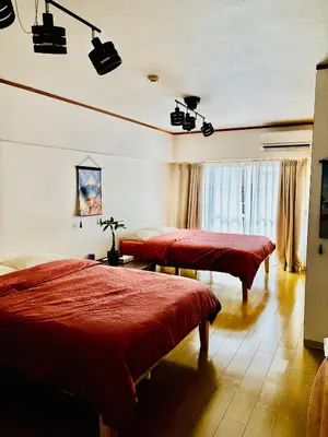 two beds in a room with red covers on them at Tokyo Ami House in Tokyo