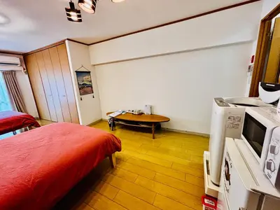a bedroom with a bed and a table in it at Tokyo Ami House in Tokyo
