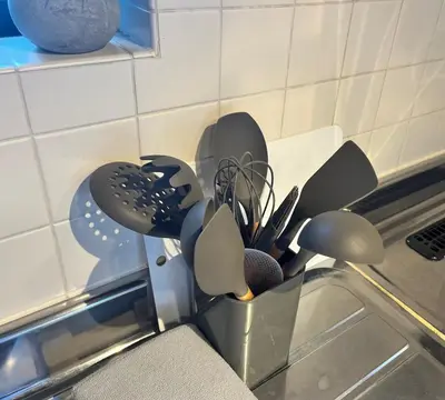 a bunch of kitchen utensils in a container on a counter at \u6771\u5dba\u753a47 in Tokyo