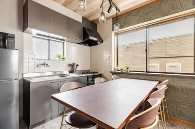 a kitchen with a wooden table and chairs in a kitchen at \u6771\u5dba\u753a47 in Tokyo